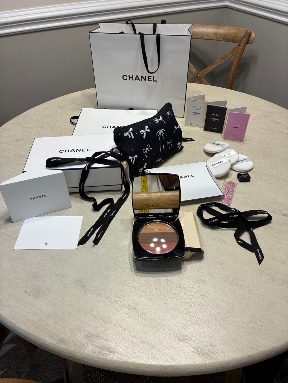 CHANEL Black Cosmetic Pouch with White Bow Motif variety bundle.